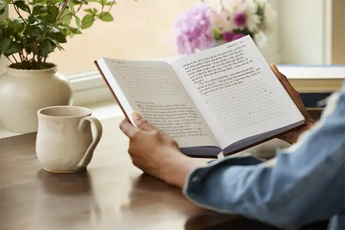 Person holding a copy of the NKJV New Testament Tracing Edition Bible